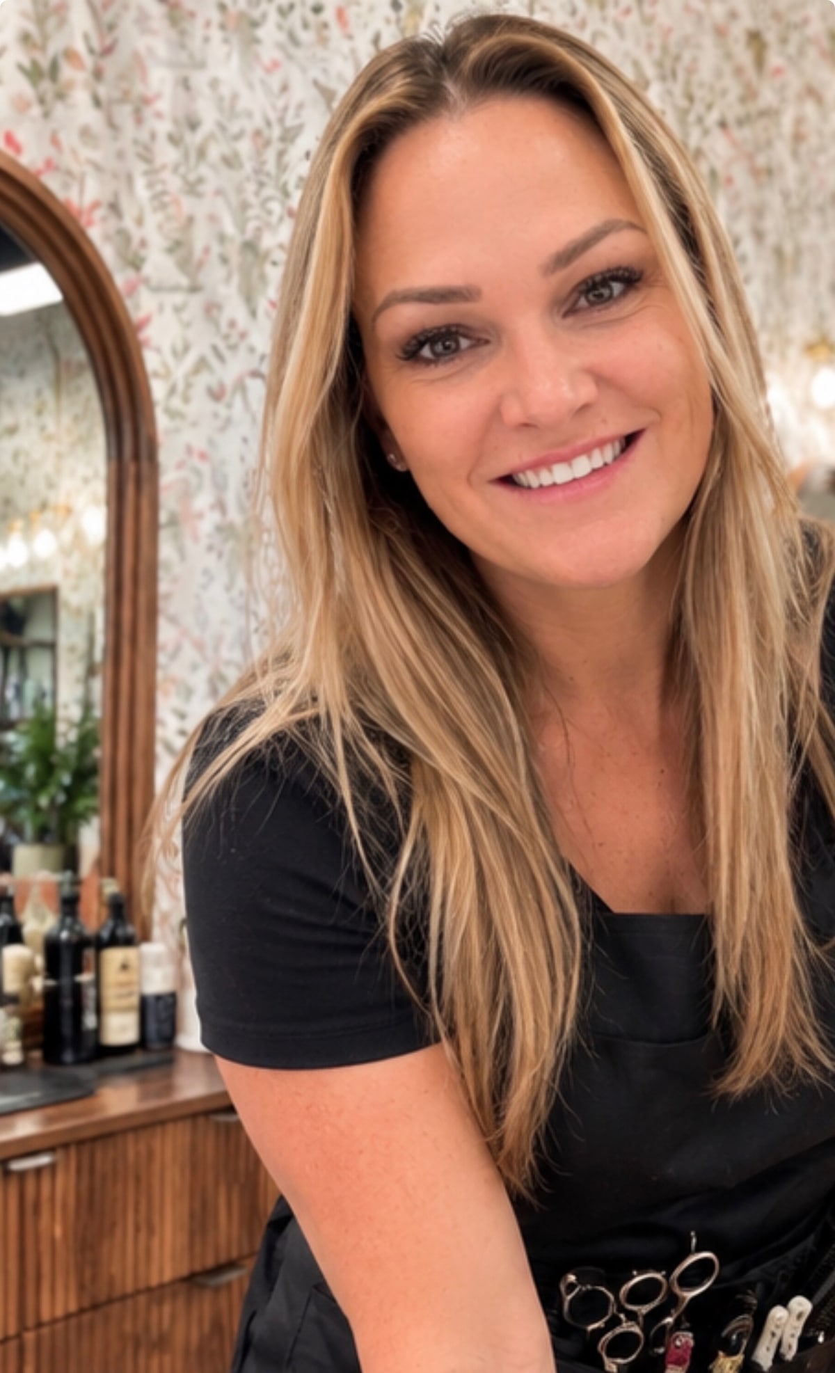 Amelia, master stylist, smiling in the In Vision Hair Design salon